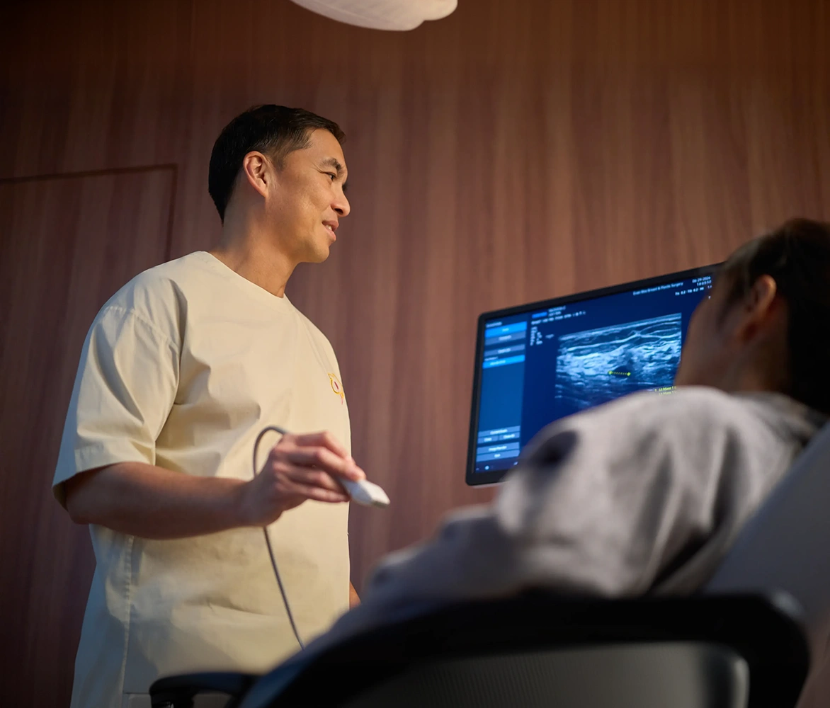 Dr. Evan Woo performing a breast ultrasound scan for a patient during a clinic consultation